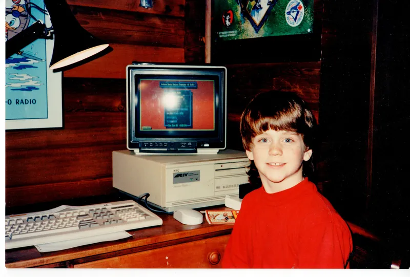 Andrew as a kid with a computer